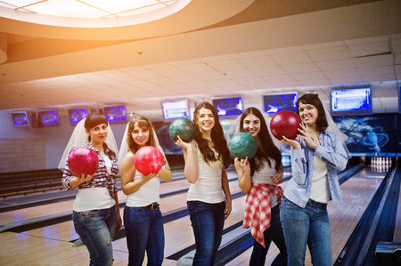 Group of six girls wit bowling balls at hen party on bowling club.の写真素材