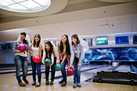 Group of six girls wit bowling balls at hen party on bowling club.の写真素材