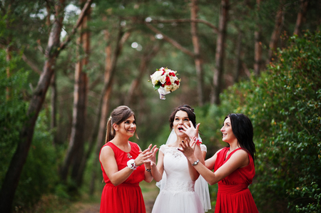 Fantastic bride with awesome bridesmaids having fun in the forest on a wedding day.の写真素材