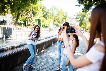 Gorgeous young girls taking photos on the treet on a sunny day.の写真素材
