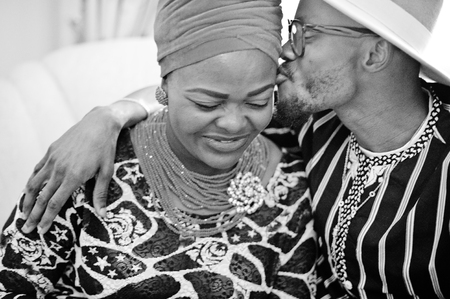 Beautiful african american woman in traditional dress and handsome black man sitting and smiling....