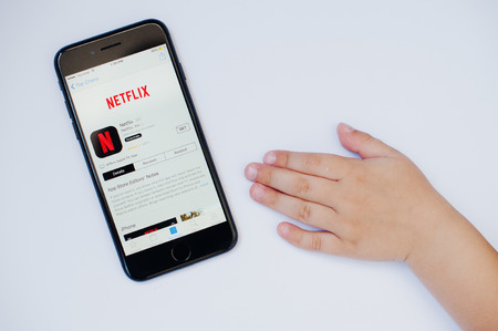 Kyiv, Ukraine - Jul 11,2017: Apple iPhone 7 with Netflix application on the screen isolated on white...