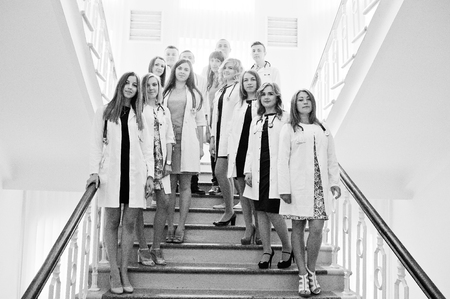 Group of young doctors in white coats posing in the hospital. Black and white photo.の写真素材