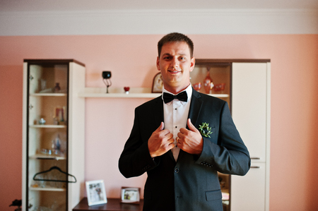 Portrait of an attractive groom dressing up for his wedding.の写真素材
