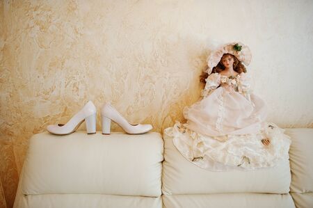Elegant bridal high-heeled shoes on the sofa.の写真素材