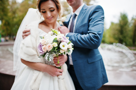 Fabulous young wedding couple posing in the park on the sunny day.の写真素材