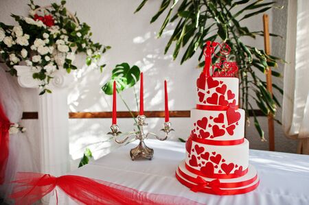 Amazing red and white wedding cake standing on the table.の写真素材