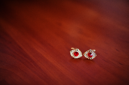 Bridal golden expensive earrings laying on the table.の写真素材