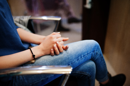 Close-up photo of bride's hands and legs in the beauty salon.