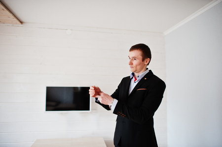 Portrait of a handsome groom dressing up and getting ready for his wedding.の写真素材