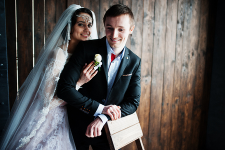 Amazing wedding couple hugging on the wooden background. Rustic style.の写真素材