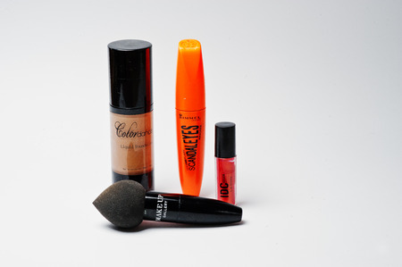 Hai, Ukraine - August 10, 2017: close-up photo of liquid foundation by Colordance, mascara by Rimmel, lipgloss by IDC Color and makeup brush Make Up Gallery on white background.のeditorial素材