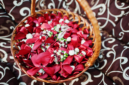 Red flower petals in the wicker basket.の写真素材
