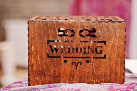 Close-up photo of a wooden brown box with inscription "wedding".の写真素材