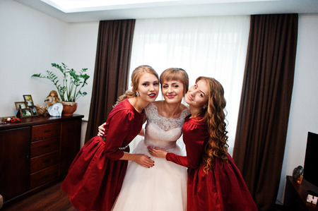 Bride with bridesmaids posing in the room on a wedding day.の写真素材