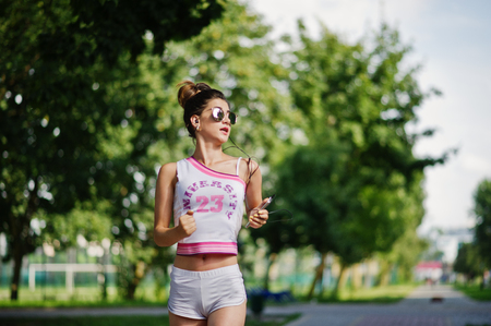 Sport girl wear on white shorts and shirt running at park.の写真素材