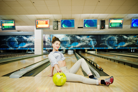Girl with bowling ball on alley played at bowling club.の写真素材