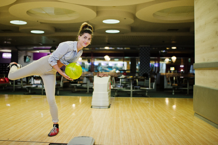 Girl with bowling ball on alley played at bowling club.の写真素材