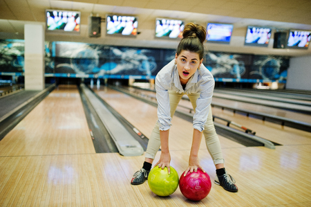 Girl with bowling ball on alley played at bowling club.の写真素材
