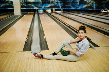 Girl with bowling ball on alley played at bowling club.の写真素材