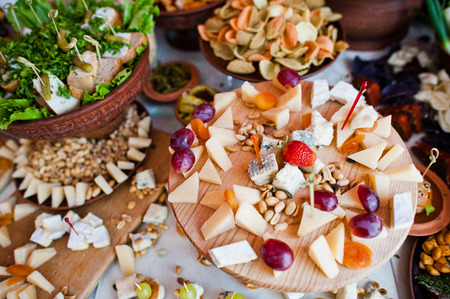 Huge variety of cheese and pickles on the wedding banquet.の写真素材