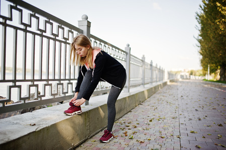 Young girl has the training and doing exercise outdoors. Sport, fitness, street workout concept.の写真素材