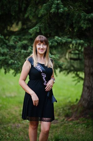 Portrait of gorgeous girl wear on black at hen party, posed at park.の写真素材