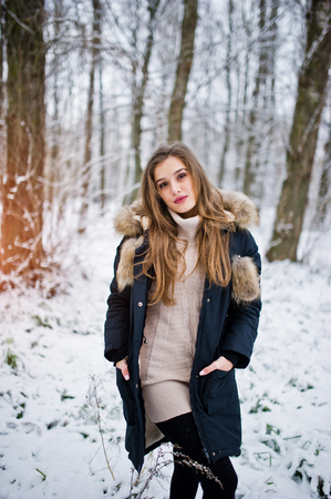 Beautiful brunette girl in winter warm clothing. Model on winter jacket.の写真素材