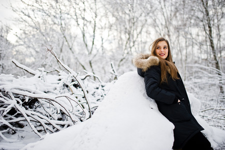 Beautiful brunette girl in winter warm clothing. Model on winter jacket.