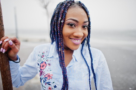 Stylish african american girl with dreads outdoor.