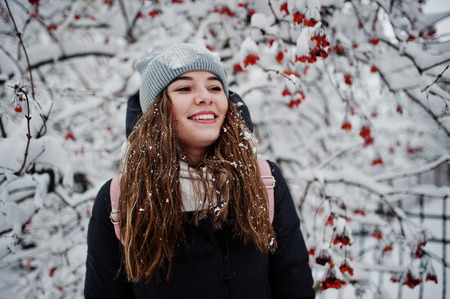 Portrait of girl at winter snowy day near snow covered trees.の写真素材