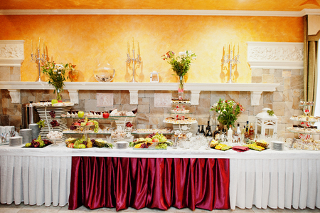 Close-up photo of a huge variety of fruits and sweet desserts on the wedding banquet.の写真素材