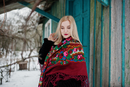 Blonde girl with hand embroidered scarf posed at winter day. Women's handkerchief.