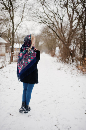 Blonde girl with hand embroidered scarf posed at winter day. Women's handkerchief.の写真素材