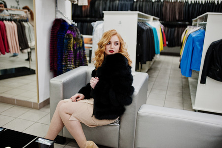 Elegance blonde girl in fur coat at the store of fur coats and leather jackets. の写真素材