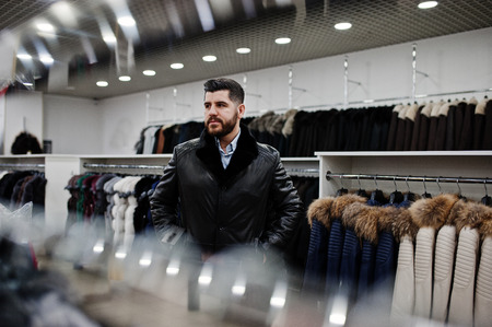 Stylish turkish man at the store of fur coats and leather jackets. Successful arabian beard man.の写真素材