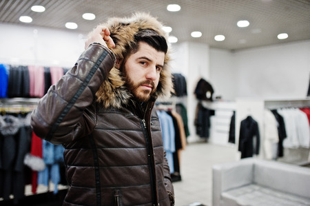 Stylish turkish man at the store of fur coats and leather jackets. Successful arabian beard man.の写真素材