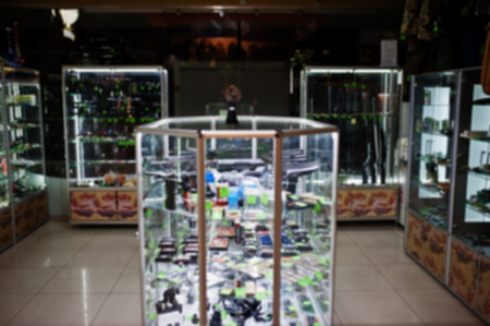 Blur photo of shelves store weapons on shop center.の写真素材