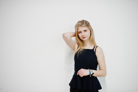 Portrait of blonde girl in black wear against white background.の写真素材
