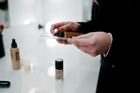Make up artist work in her beauty visage studio salon. Woman professional make up master. Beauty...