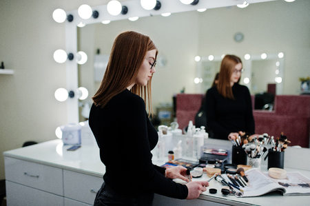 Make up artist work in her beauty visage studio salon. Woman professional make up master. Beauty club concept.の写真素材