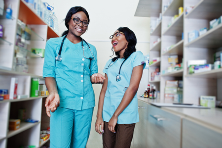 Two african american pharmacist working in drugstore at hospital pharmacy. African healthcare.の写真素材