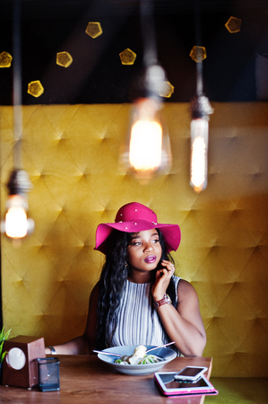 African american business woman sitting in cafe and eating salad.の写真素材