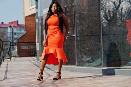 African american woman model xxl in orange dress.の写真素材
