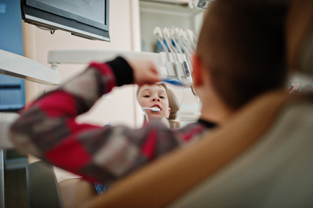 Little boy at dentist chair. Children dental.の写真素材