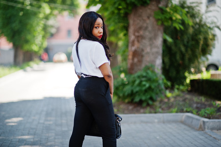 Stylish african american business woman on streets of city.の写真素材