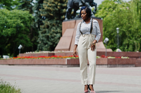 Stylish african american business woman at trousers with suspender and blouse posed outdoor.の写真素材