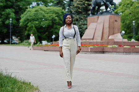 Stylish african american business woman at trousers with suspender and blouse posed outdoor.の写真素材