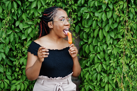 Stylish african american woman at glasses with ice cream.の写真素材