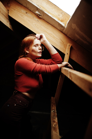 Fashion portrait of redhaired sexy girl on roof. Model attractive seduction woman.の写真素材